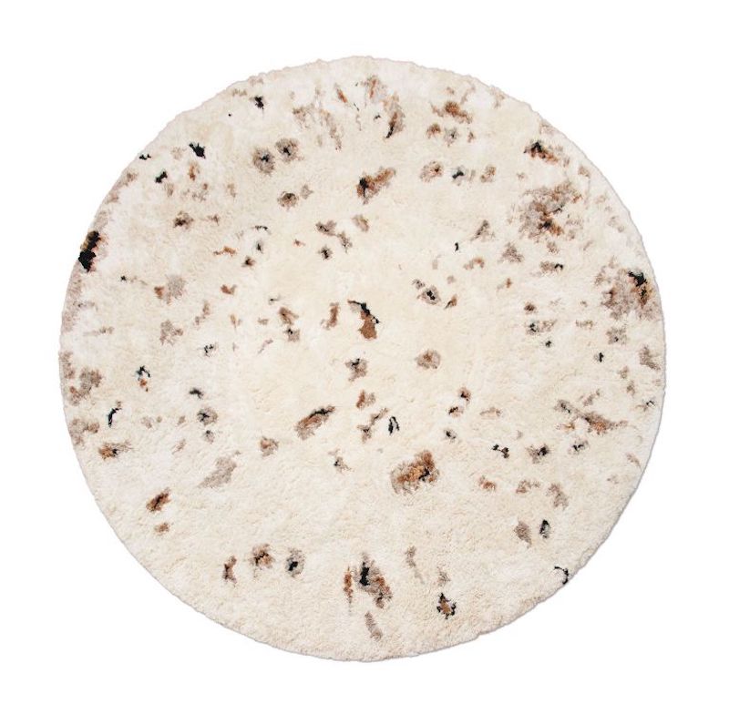 white round rug with a few of brown hues with a shaggy and fluffy texture. Wool Rugs: Create The Perfect Reading Nook For The Fall