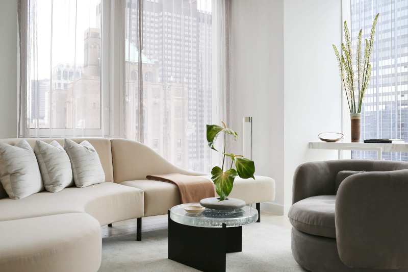 Rafael de Cárdenas, velvet white sofa, gray armchair, New York view, white rug