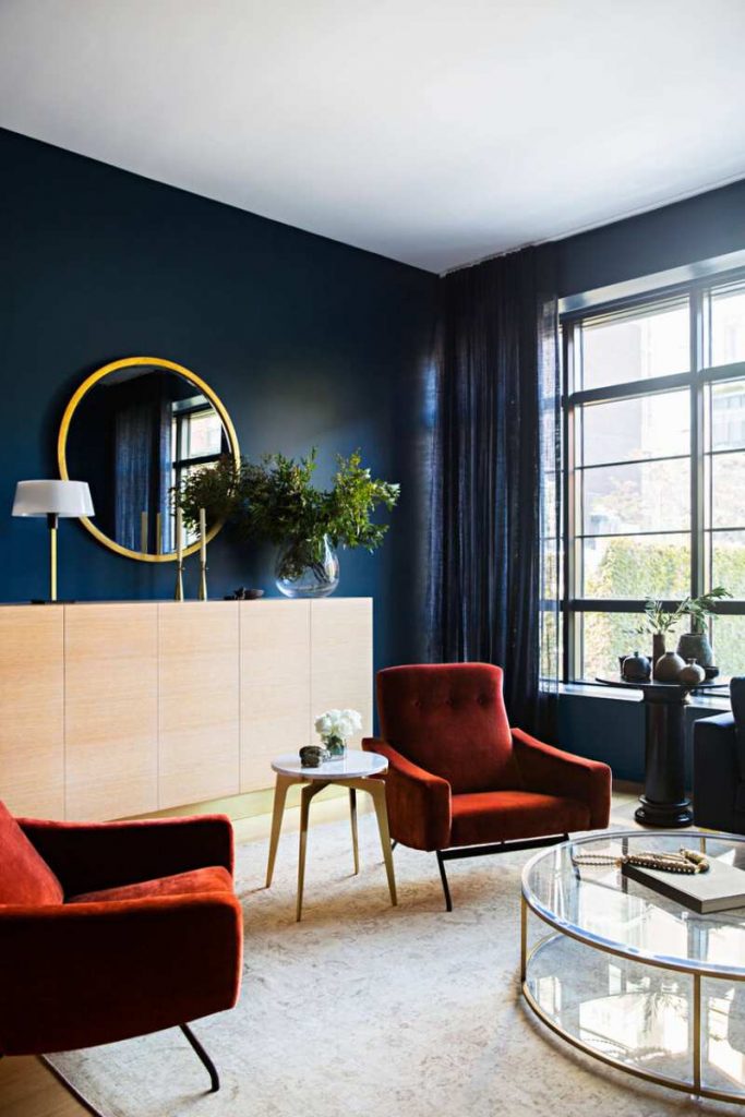 Jeremiah Brent, modern living room, contemporary furniture, white rug, velvet upholstery, red armchair, blue walls