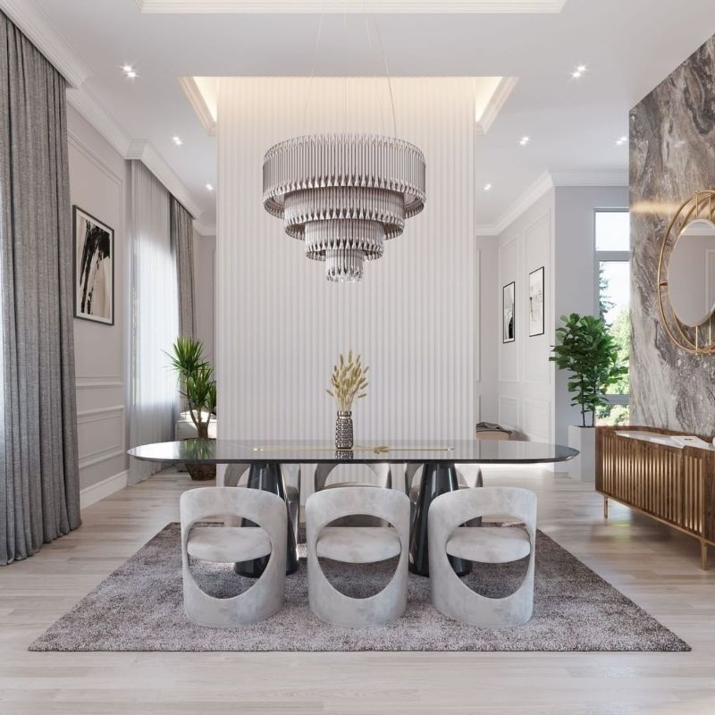 mid-century dining room in gray tones with area rug and dining chairs and silver chandelier