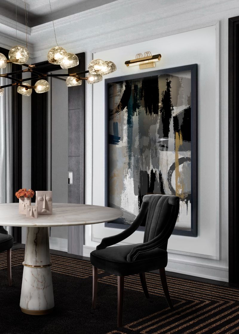 modern dining room with black and gold rug, black dining chair and marbled white dining table