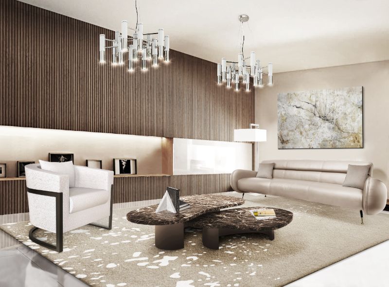 all-neutral living room with beige area rug and center table with silver hanging lights