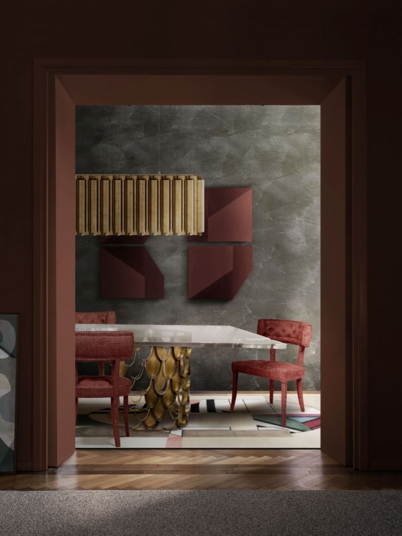 The Oscar rug is a gorgeous dining room with a geometric pattern inspired by the art movement cubism. The neutral colors of the rug make it easy to pair with any type of furniture. The red dining chairs add color to this space and the Koi dining table and suspension lights add elegance.