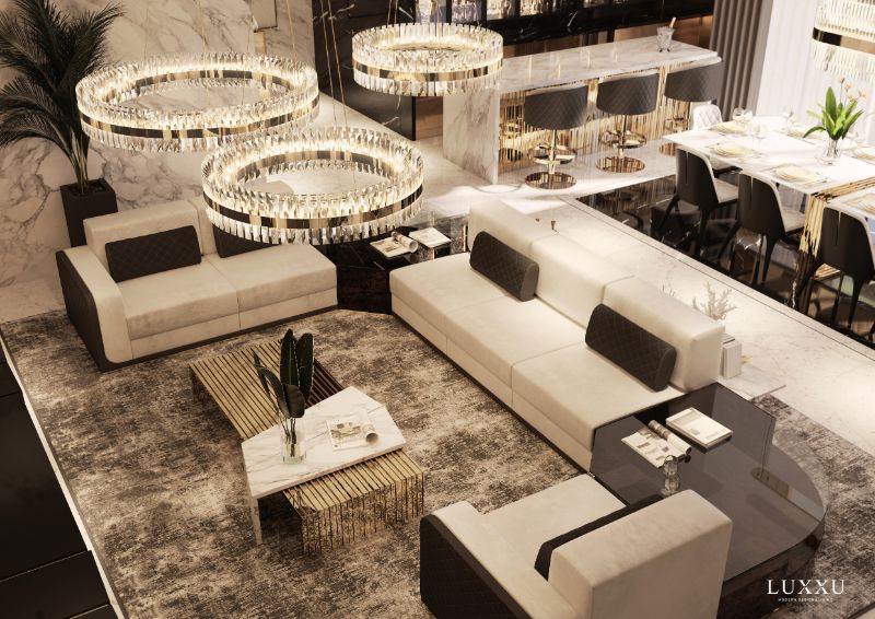 luxurious living room with gray area rug, round hanging lights and golden center table