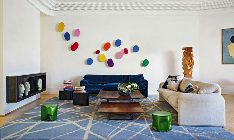 living room by ines benavides with blue rug, blue sofa, white sofa and green side tables