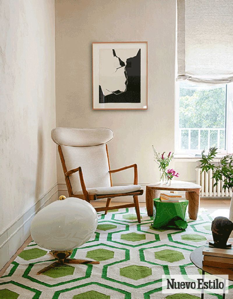 living room by ines benavides with green rug, white armchair, brown coffee table and green side table