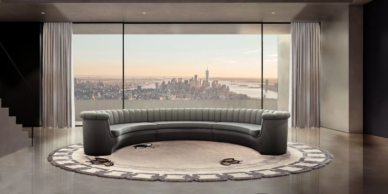a contemporary modern living room with a round rug with neutral colors and butterflies paired with a curved sofa.