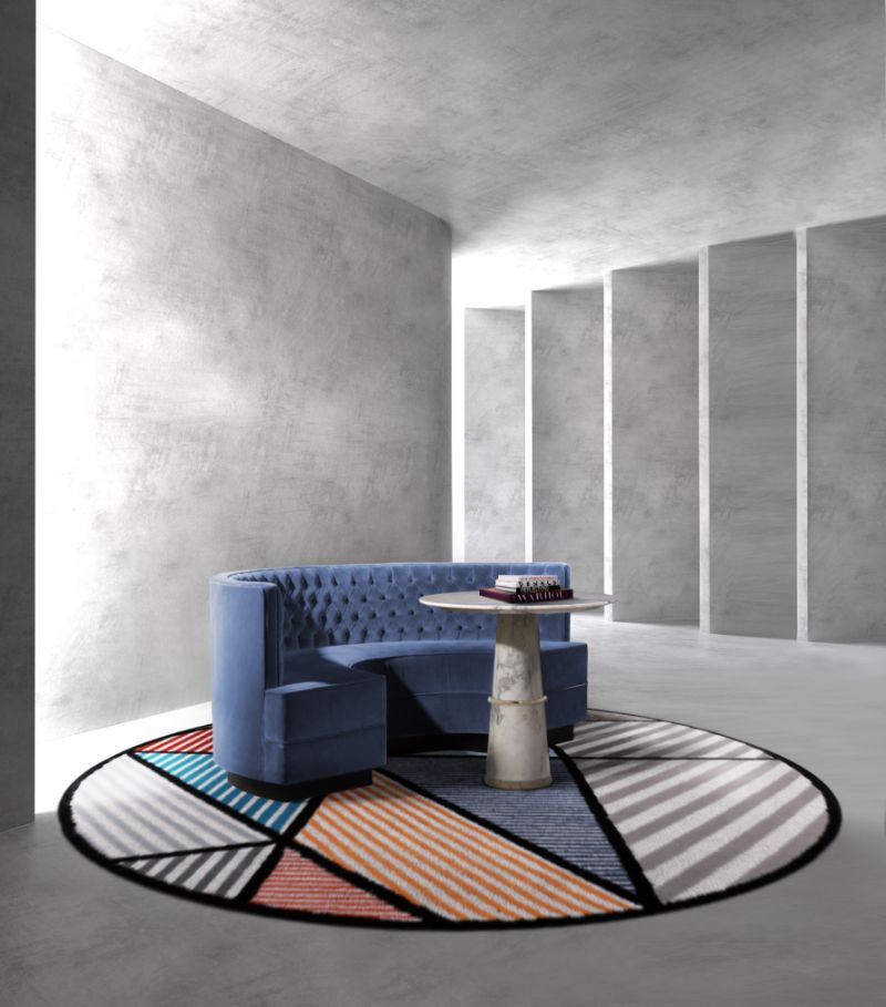 Modern contemporary living room with round colorful rug and blue curved sofa. Modern Classic Rug Ideas For the Living Room