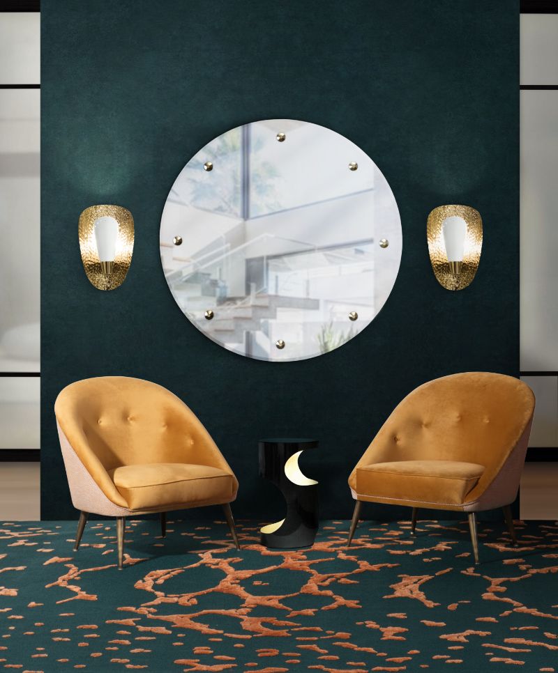 Contemporary living room with orange and dark colored rug with contemproary armchairs and round mirror. The Best Botanical Rugs With A Mystical Aura
