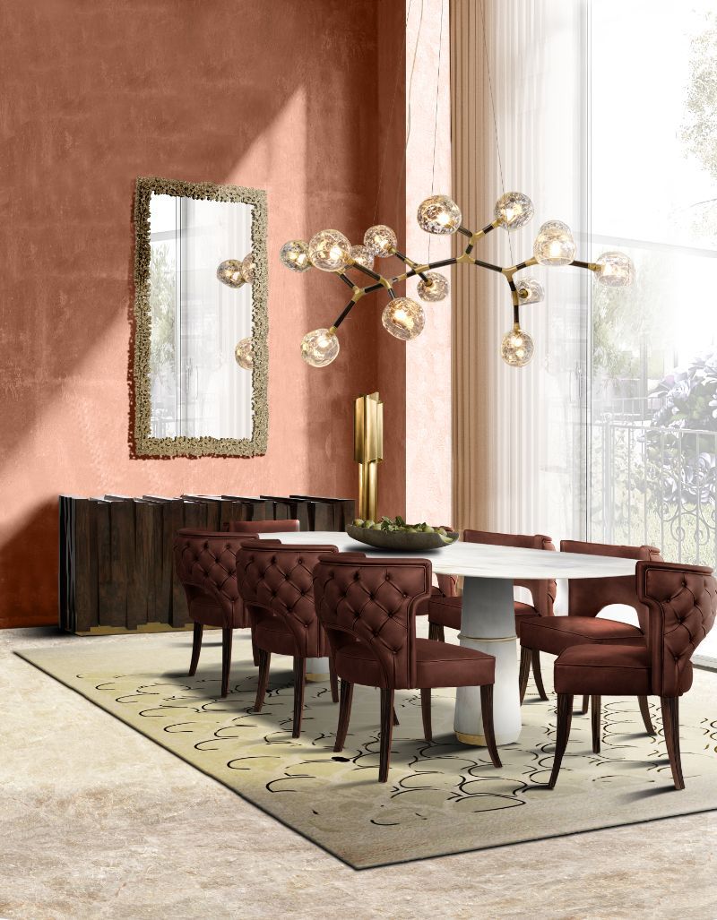Elegant modern contemporary dining table with area rug in soft beige tones that contrast with the red dining chairs, The Best Modern Rugs To Match With Marble Furniture