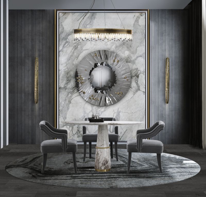 monochrome dining room in tones of blue and gray with a round rug that has an abstract pattern and round dining table. The Best Modern Rugs To Match With Marble Furniture