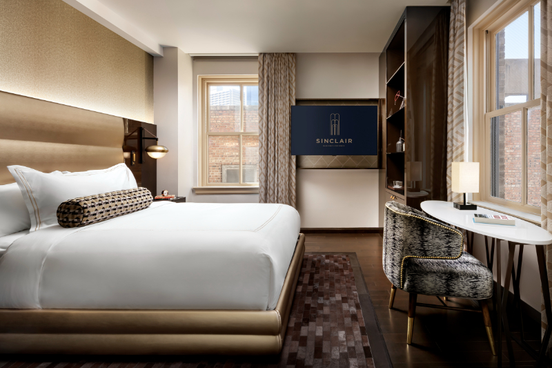 Forrest Perkins: Contemporary Rugs In Hospitality Projects. Hotel room in brown and gold tones with a textured rug.