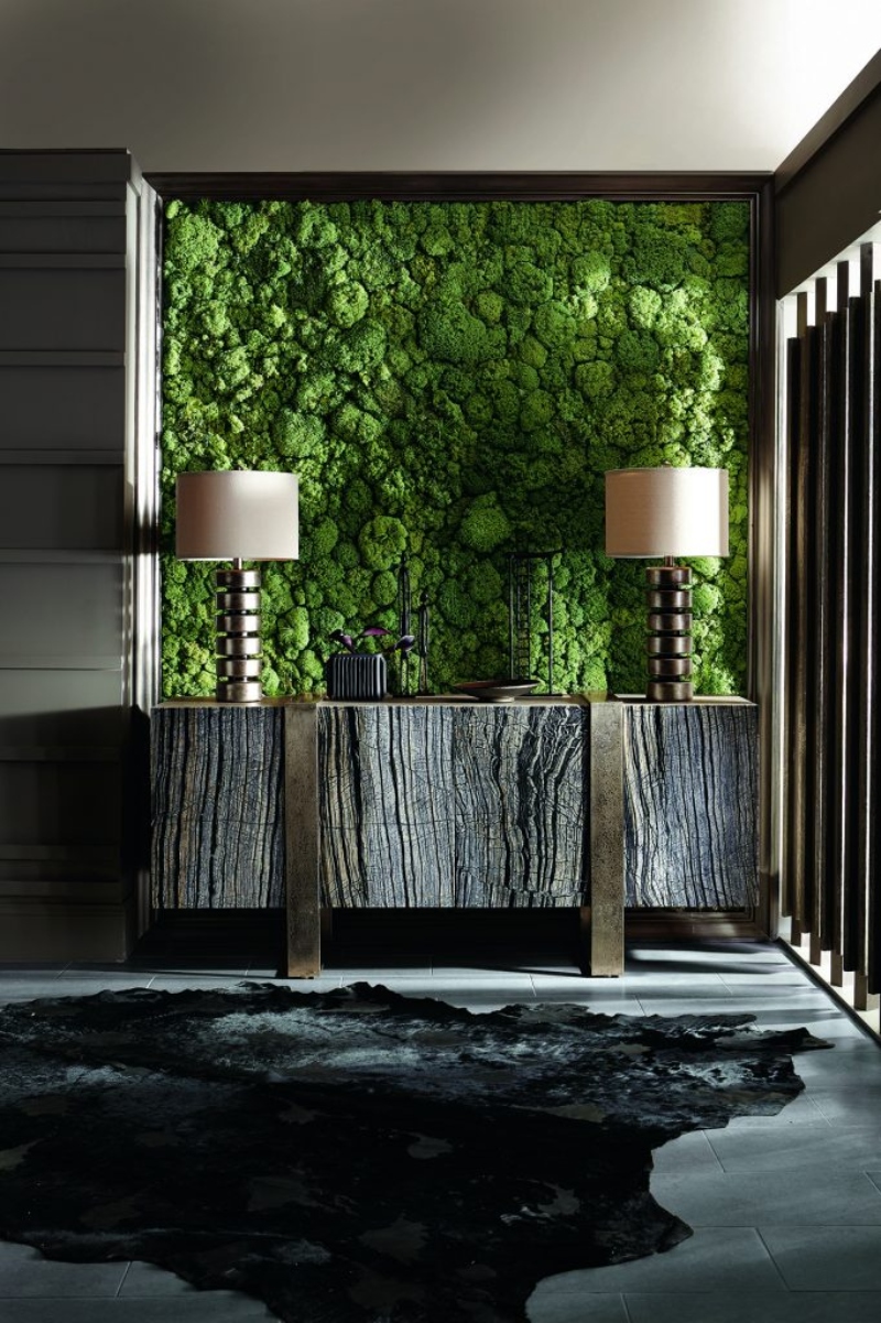 Rug Décor with Import Temptations. This dark entryway as a feature wall has a green texture, a dark console, and a black rug.