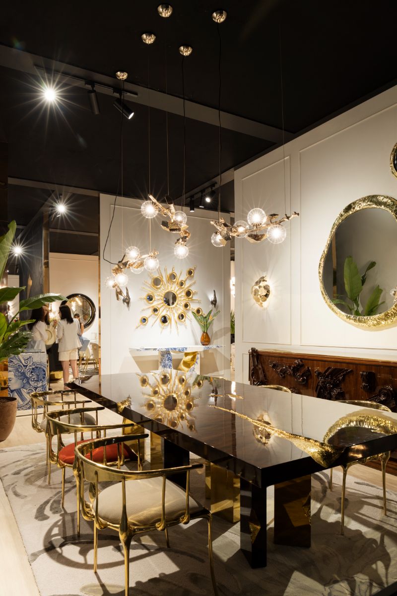 A dazzling and luxurious dining room with a green neutral area rug at Salone Del Mobile