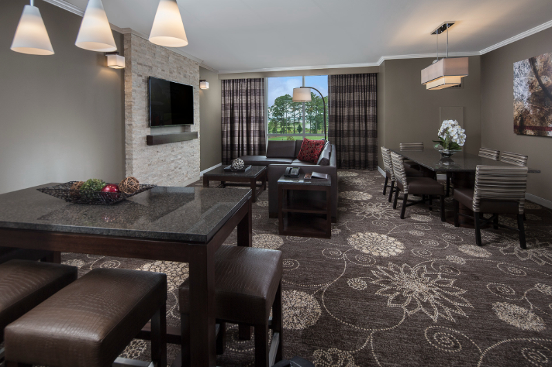 Abel Design Group: Rug Design Inspiration. Living and dining room with a carpet with a flower pattern.