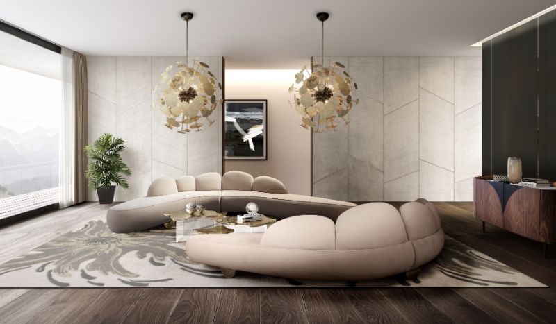 neutral area rugs with soft pastel green rug and 2 curved sofas in light beige with pendant lighting.