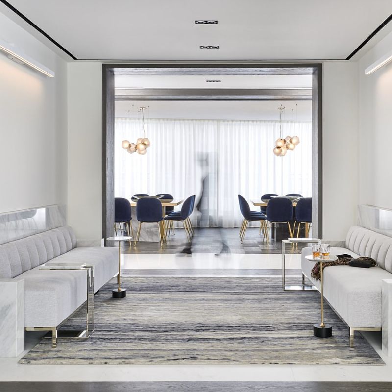 Maxine Tissenbaum And The Art of Bespoke Interior Designs. luxurious living room and dining room with area rug.