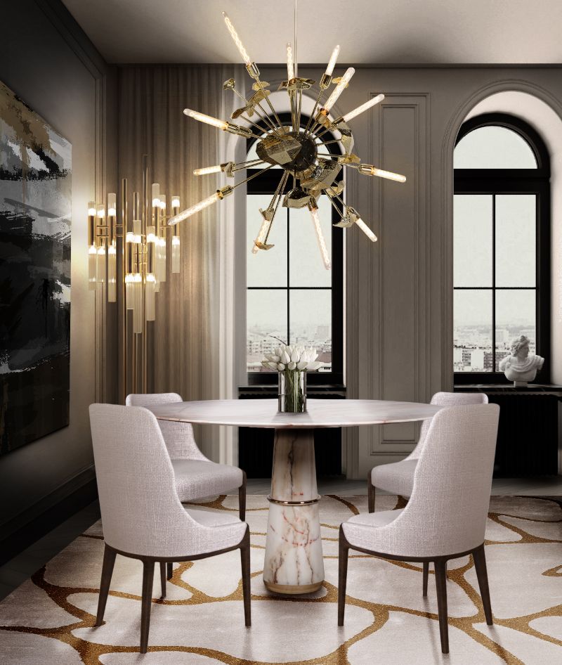 The AGRA dining room table has a faux marble design that radiates opulence and matches beautifully with the CELL RUG's pattern. The white and rusty orange hues of this dining room create a warm and inviting space that will make your guests feel at ease.