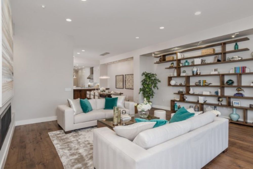 20 Clever Ways to Decorate Your Living Room with Modern Wool Rugs. Modern living room with area rug in white and brown. white sofa, blue pillows,