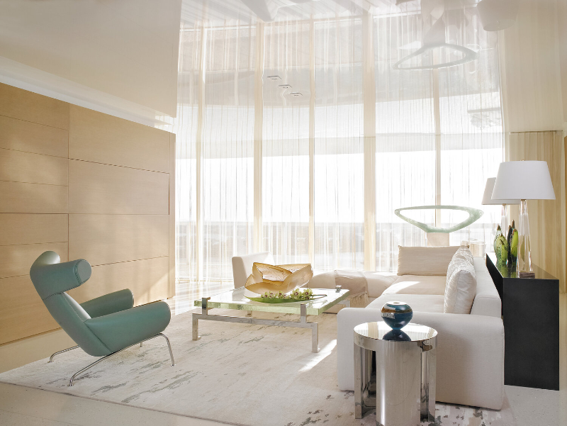Michael Wolk - Murano Grande. Living room in white with a green armchair.