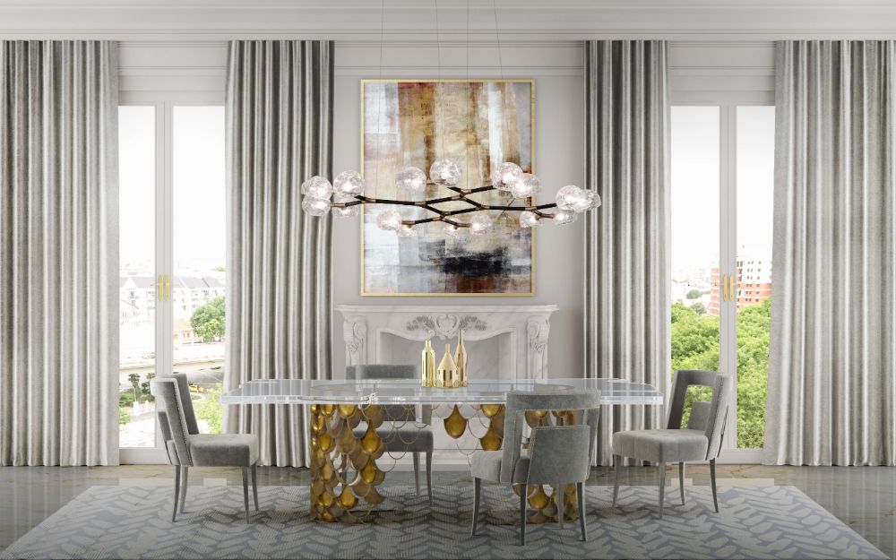 Modern dining room with Koi rug in tones of blue and Koi dining table in gold and suspension lights