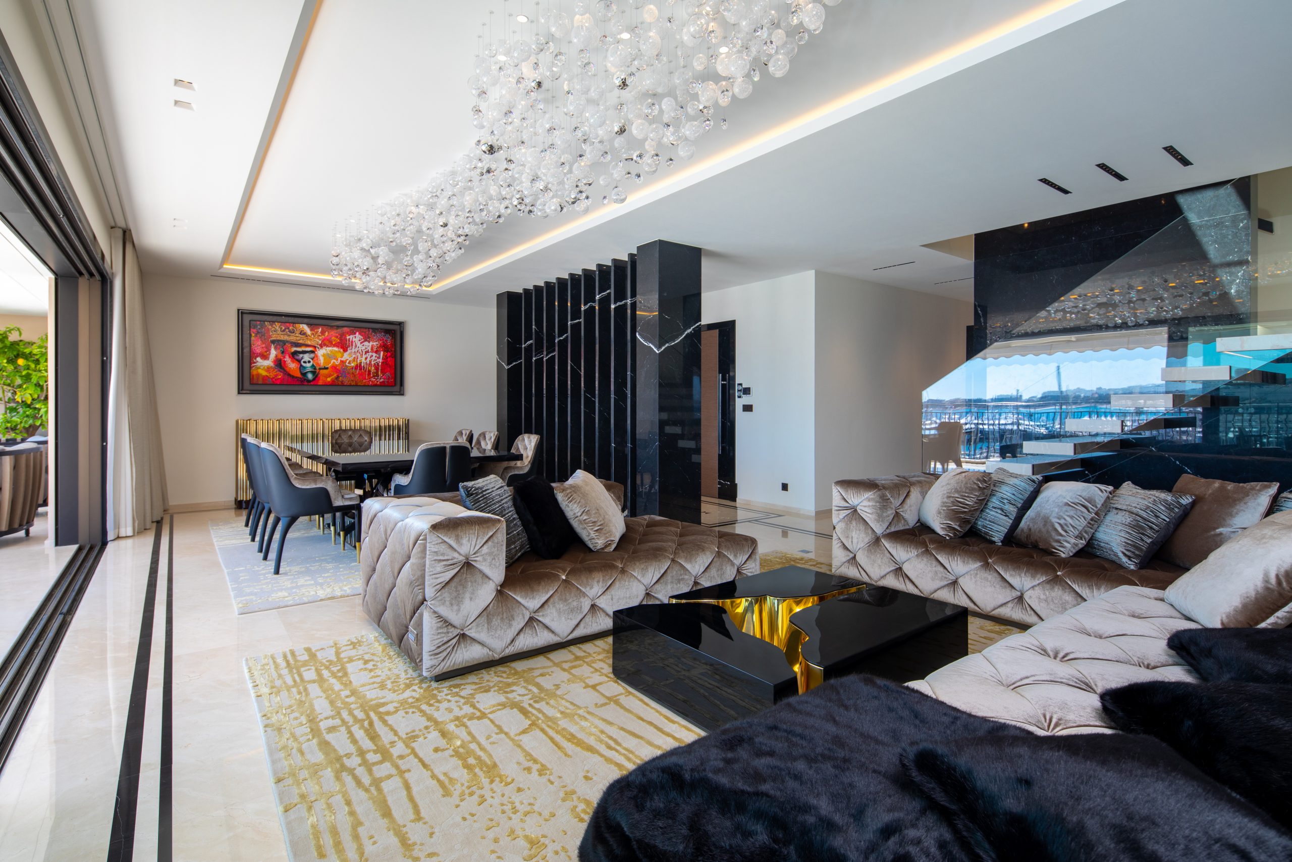 Living room with area rug in gold, velvet sofas
