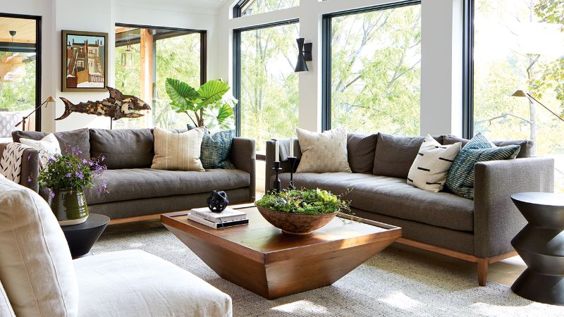 Living room with area rug and center table with gray sofas