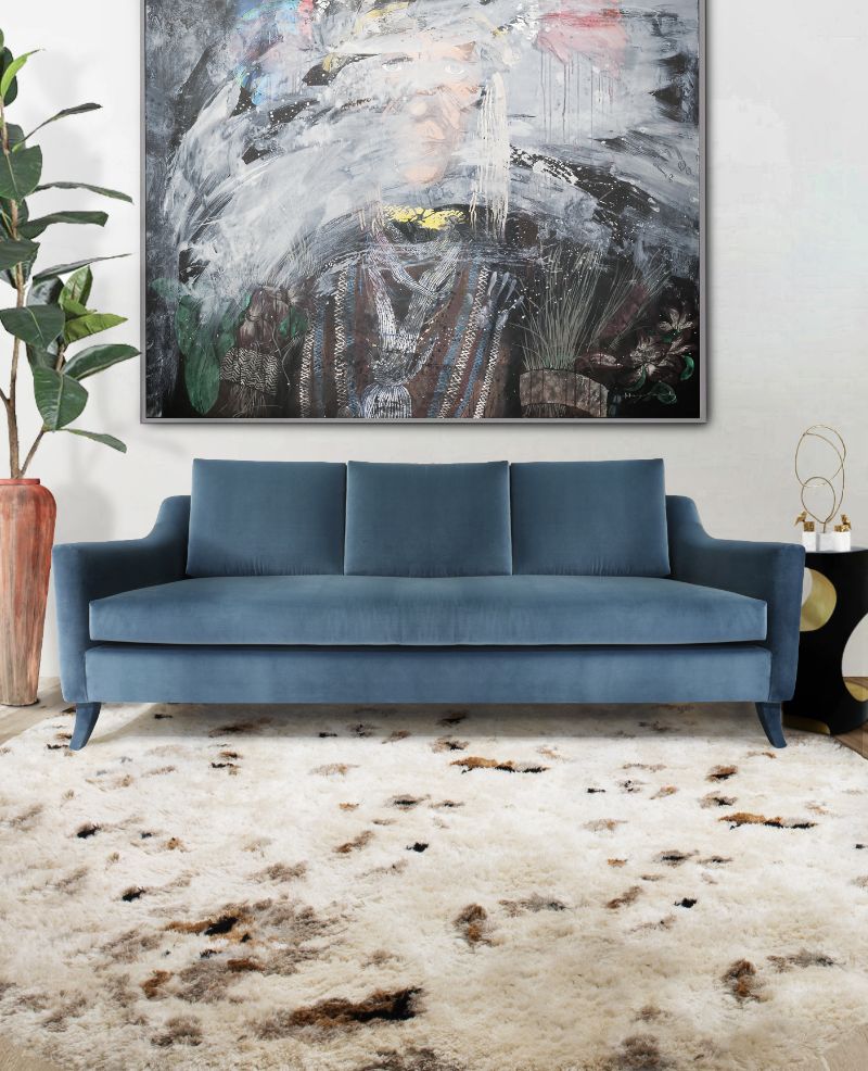 contemporary living room with oslo rug, blue sofa and beautiful painting