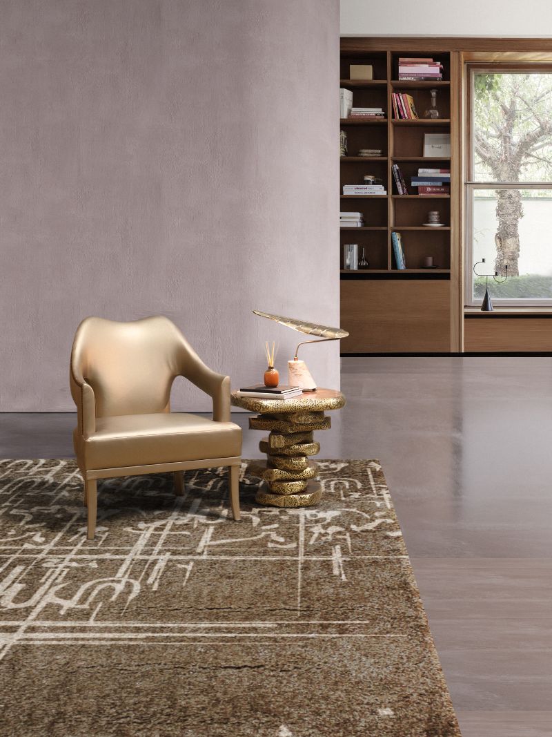 Modern contemporary living room with Black ink rug in brown paired with gold armchair and gold sidetable with a lamp.