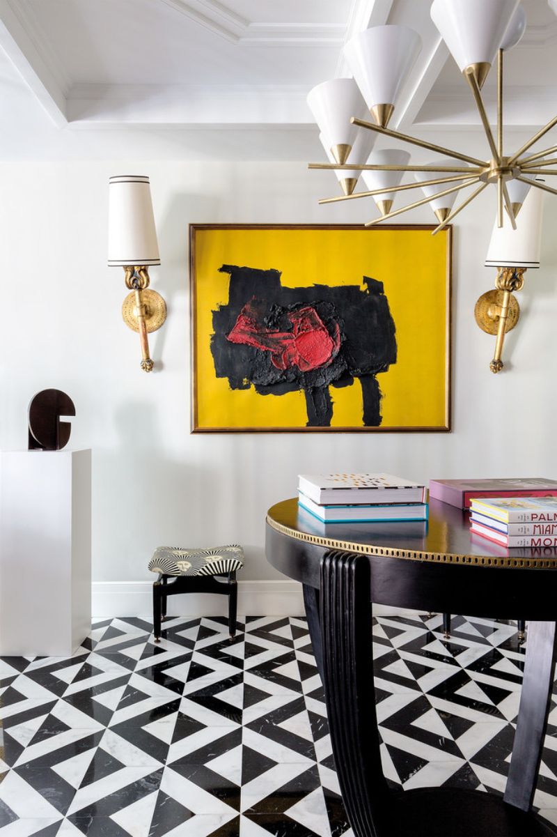 abstract painting, golden and white suspension lamp, black table, white wall lamps