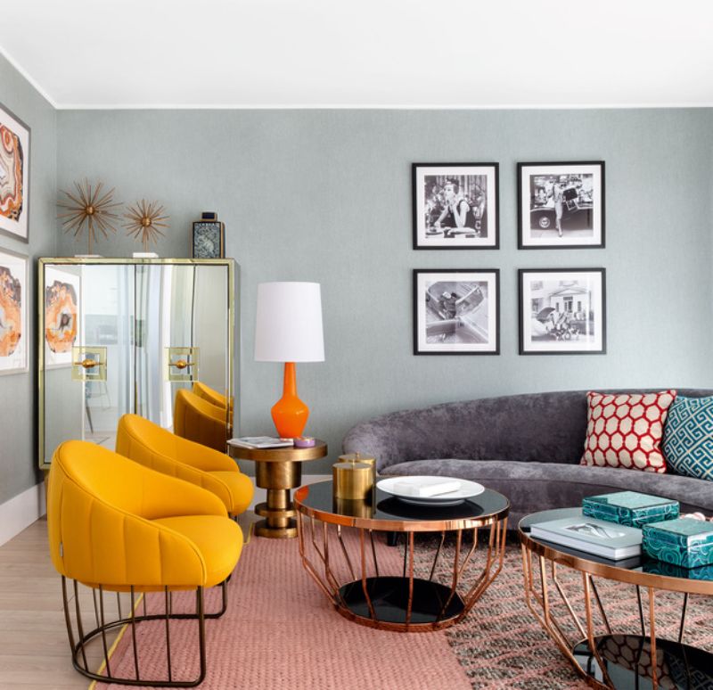 grey sofa, yellow armchairs, orange lamp, black an golden center tables