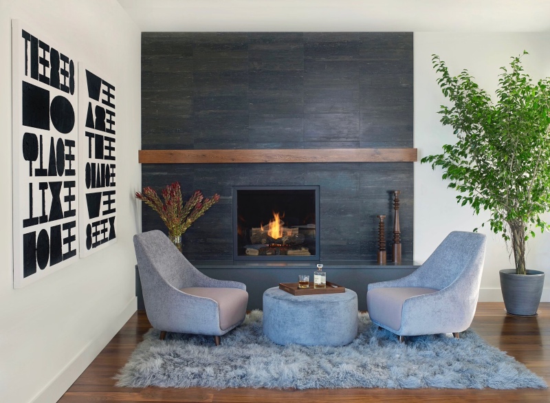This contemporary living room design exudes peace and warmth with blue rug design inspiration.