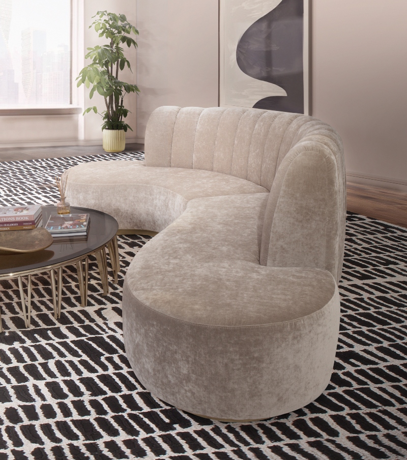 Rug Design Inspiration by Camden Lane Interiors. This neutral living room has a neutral sofa and a black and white rug that covers all of the room.