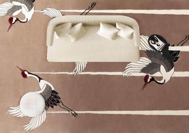 2022 milan furniture fair: living room with neutral rug with bird design. and white sofa