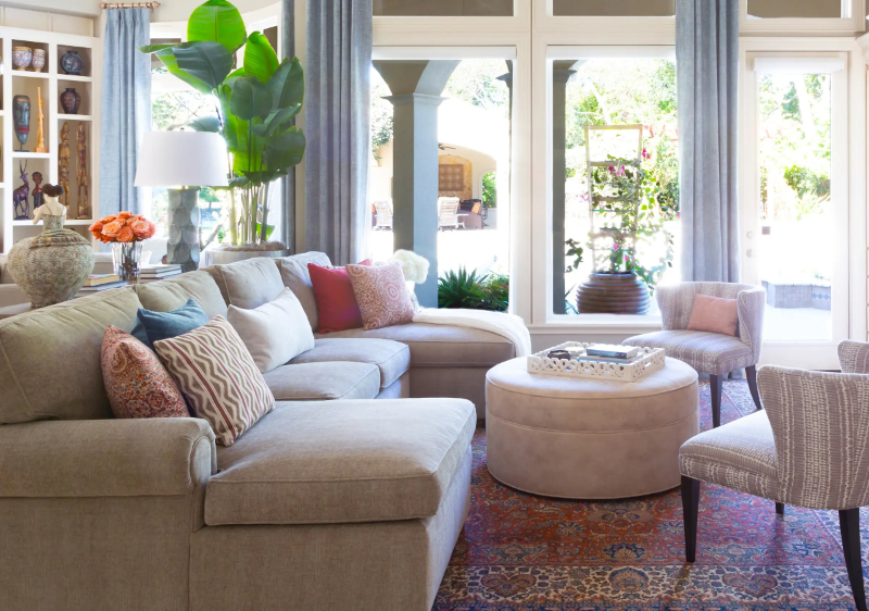 Rug Design Inspiration by Karen Davis. A natural-looking sofa with chairs on either side and a coffee table.