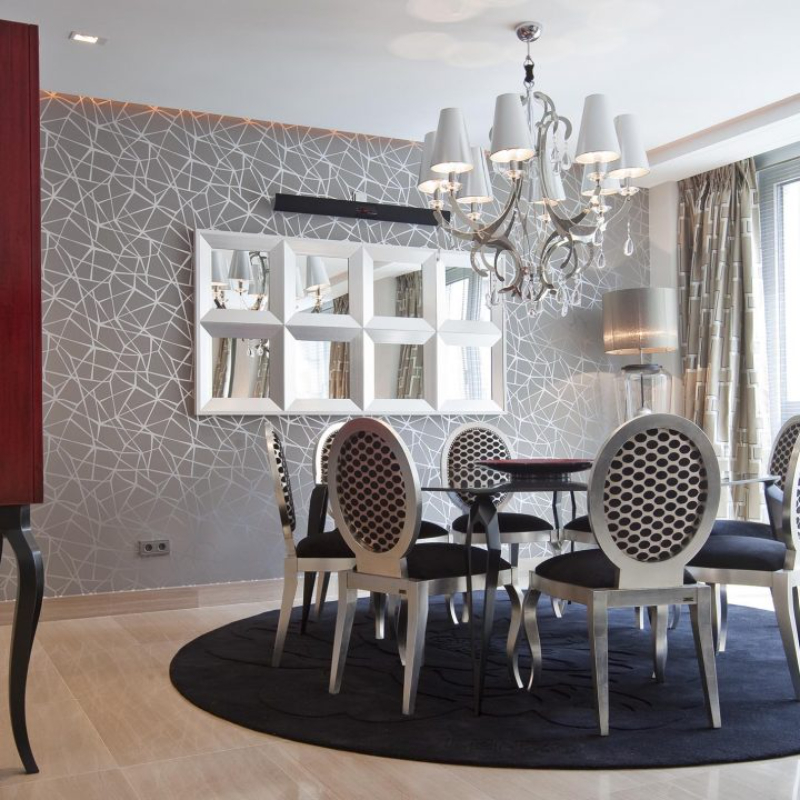 dining room by Carrillo Proyectos with black rug and black chairs