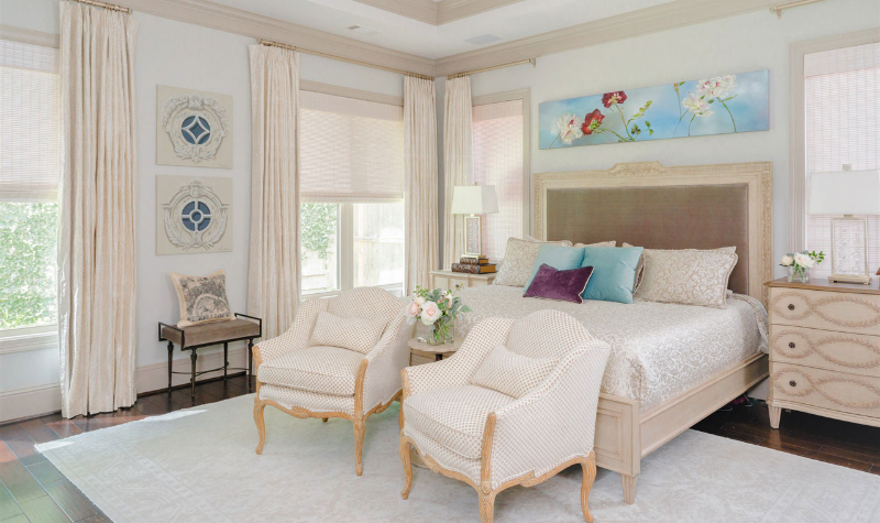Rug Design Ideas From Pamela Hope Designs. In this bedroom the main colors are white and beige. There's a large rug under the bed and under the two single sofas.
