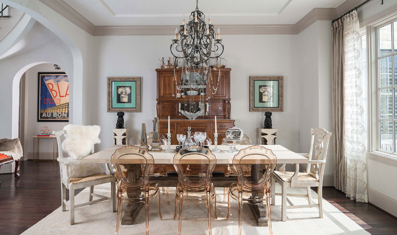 Rug Design Ideas From Pamela Hope Designs. A dining room with a combination of ghost chairs and two arm chairs. There's a light colored rug.