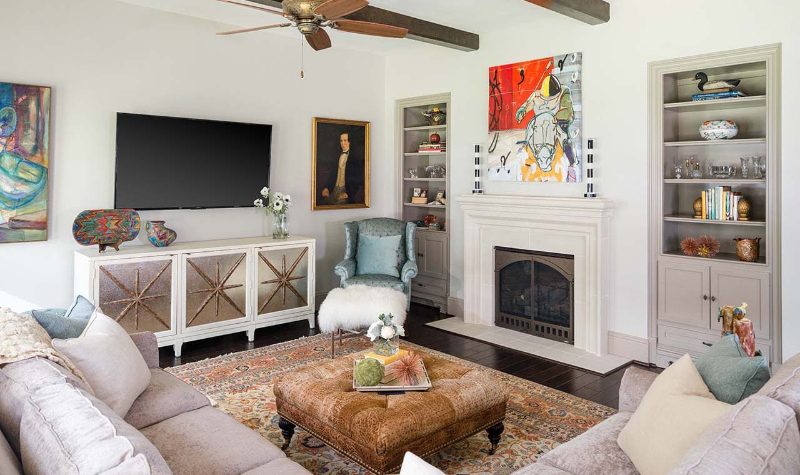 Rug Design Ideas From Pamela Hope Designs. A L-shaped sofa, with a square center table, on a rug in tones of brown.