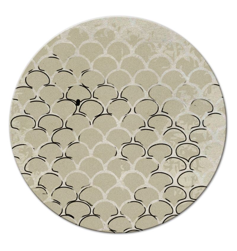 neutral round rug with a scaled pattern inspired by the scales of a fish. dining room rug