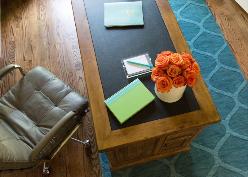 Rug Design Inspiration by Karen Davis. This office has a blue rug with a geometric pattern.