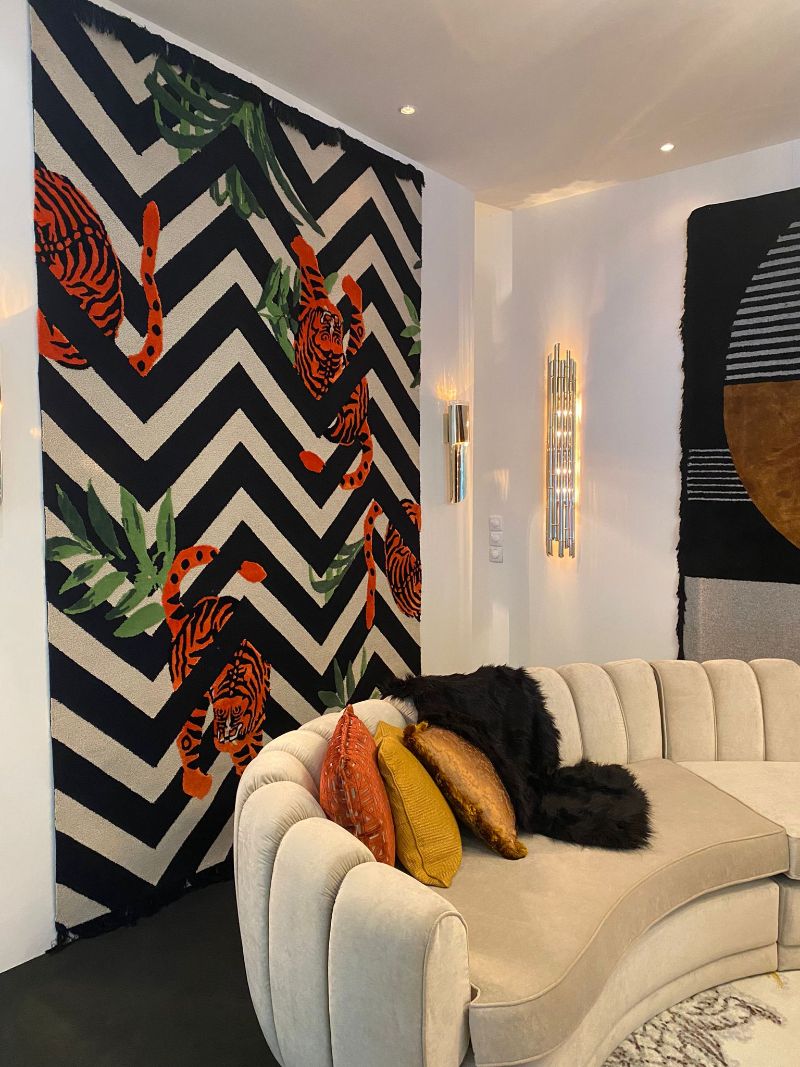 iSaloni Fair: modern rug in black and white with a pop of color and a tiger trapped within the striped design.