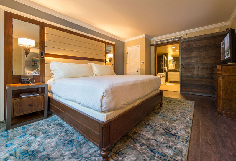 Rug Design Inspiration From Duncan & Miller Design. A wide rug under the bed and bedside table. Its colors are blue tones and gray.